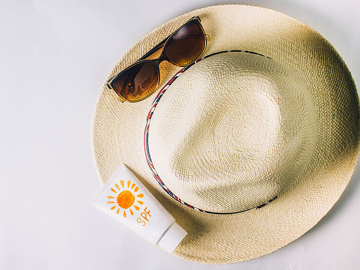 Beach accessories. Summer hat, sunglasses and suntan lotion