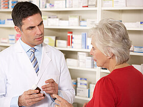American pharmacist with senior woman in pharmacy